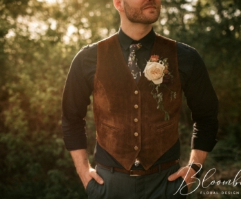 Rustic Groom wearing Rose Boutonniere and Greenery