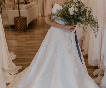 Bride in Designer Wedding Gown Holding Loose Greenery Bouquet