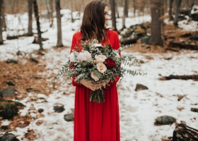 Bride in Red Dress holding Bouquet of White Blush and Merlot Flowers